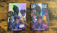 a set of comic books on a wooden table